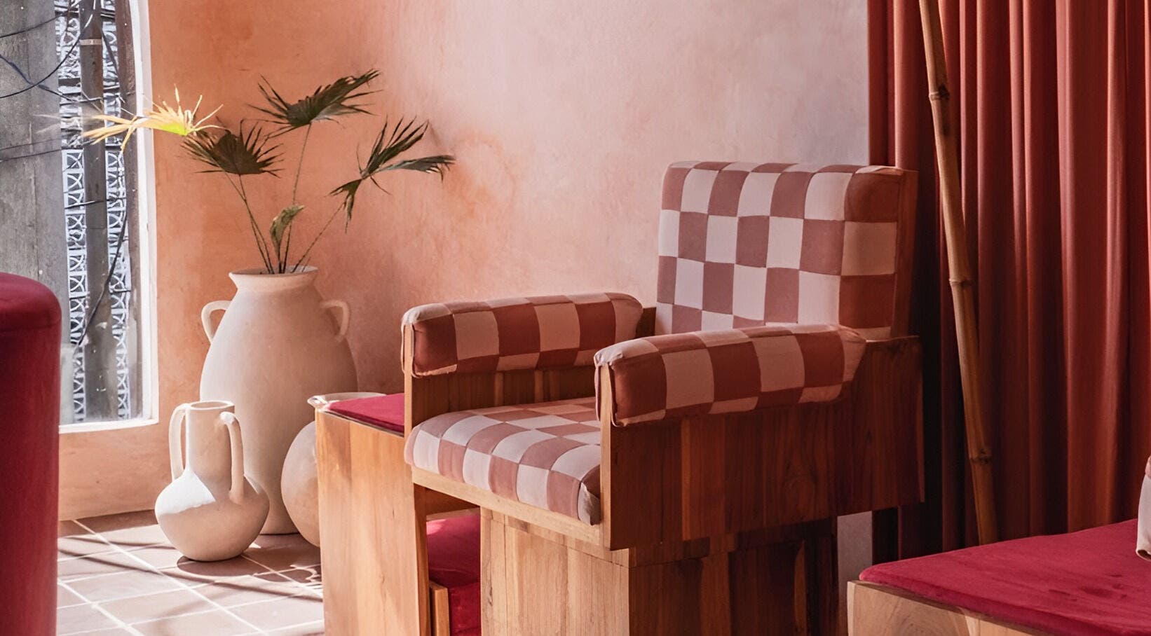 Chic seating at Rosie's Nail Bar - Canggu, Badung, Indonesia, ID with checkered chair and pottery decor.