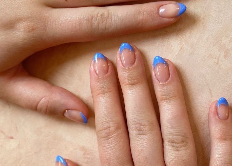 Elegant blue French manicure at Rosie's Nail Bar - Canggu, Badung, Indonesia, ID. Perfect blend of style and care.