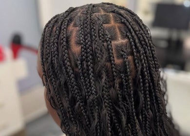 Intricate braided hairstyle at Hair by Kiandra, Marigot, MF showcasing professional salon craft.