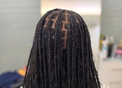 Intricate hair braiding style at Hair by Kiandra, Marigot, MF showcasing precision and artistry.