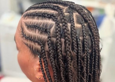 Intricate braid style at Hair by Kiandra, Marigot, MF. Showcasing detailed cornrows and artistic design.