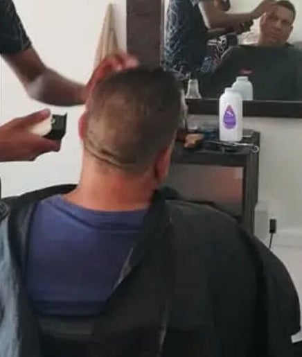 Barber at The Village Barbershop in Cape Town, Western Cape, ZA performing a stylish haircut.