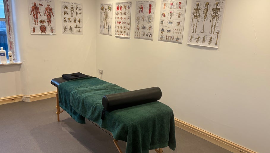 Massage room at What Knot Sports Massage Therapy, Preston, England, GB, featuring anatomical charts.