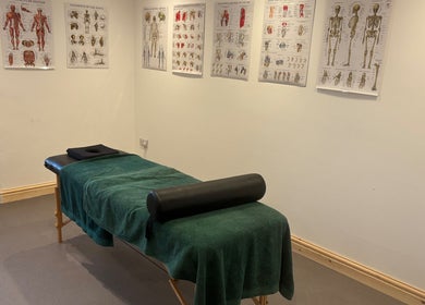 Massage room at What Knot Sports Massage Therapy, Preston, England, GB, featuring anatomical charts.