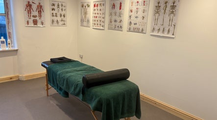Massage room at What Knot Sports Massage Therapy, Preston, England, GB, featuring anatomical charts.