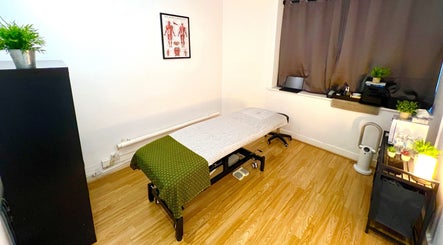 Calm massage room at Urban Therapy - Massage Clinic & Body Treatments, London, England, GB with a cozy setup.