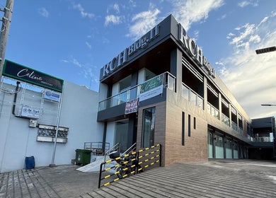 Modern exterior of RCH Bldg with clear signage, near Charmed Nails & Coffee Studio, Meycauayan, Central Luzon, PH.