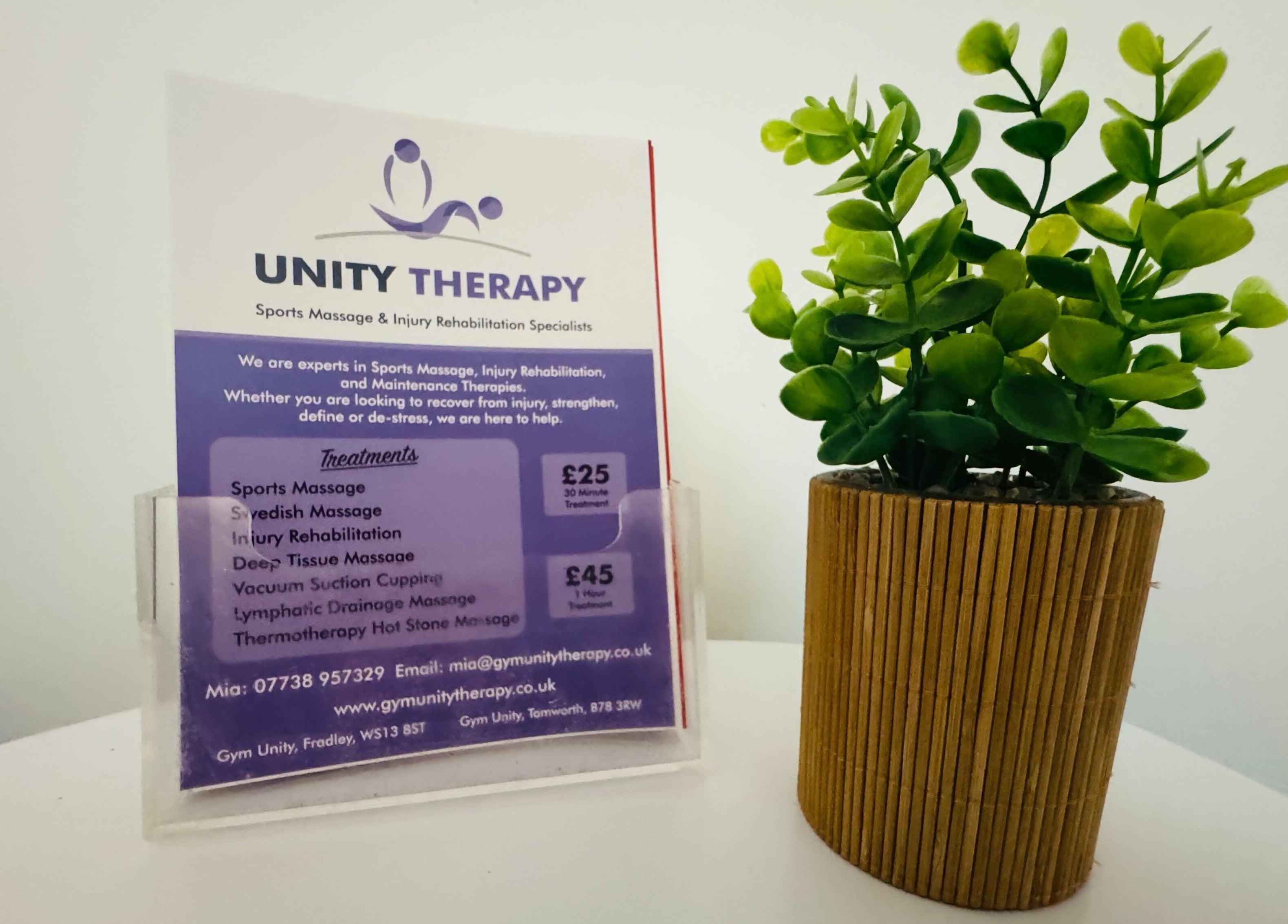Service menu at Unity Therapy - Tamworth - B78 3RW beside a decorative plant in Fazeley, England, GB.