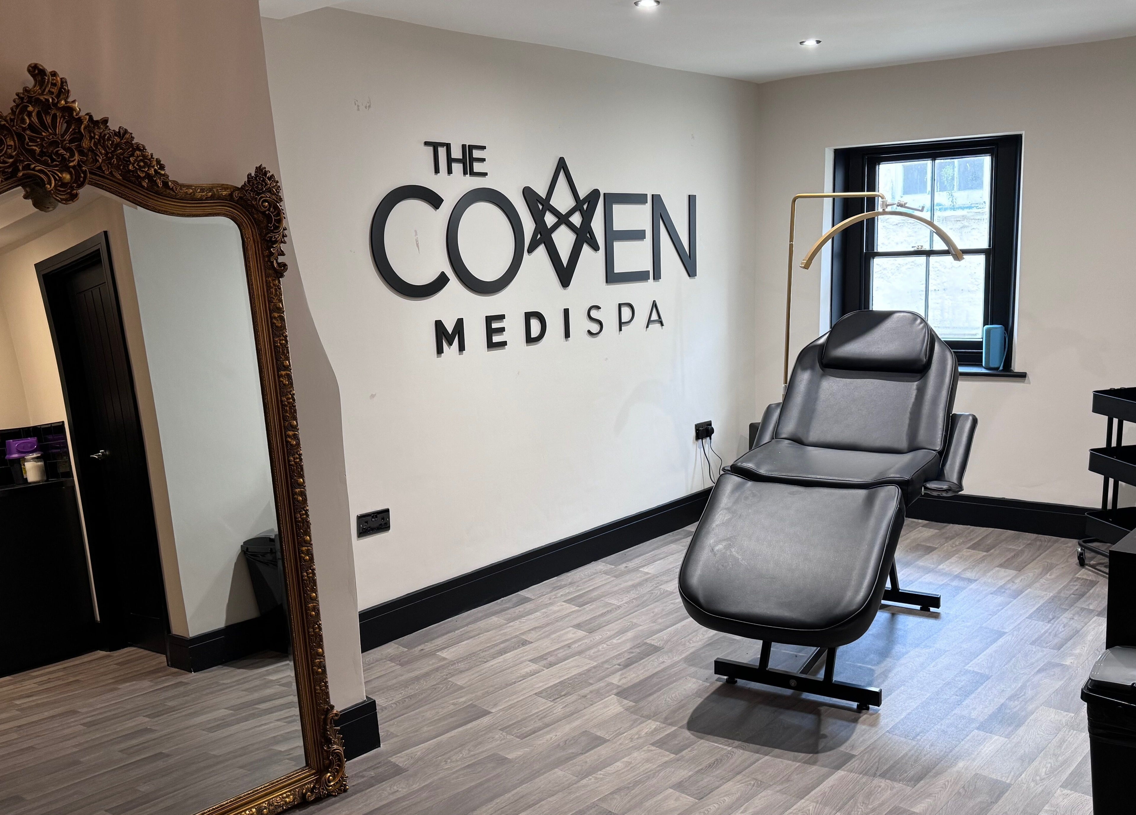 Interior of The Coven- Medi Spa in Bridgend, Wales, GB featuring a reclined spa chair and ornate mirror.