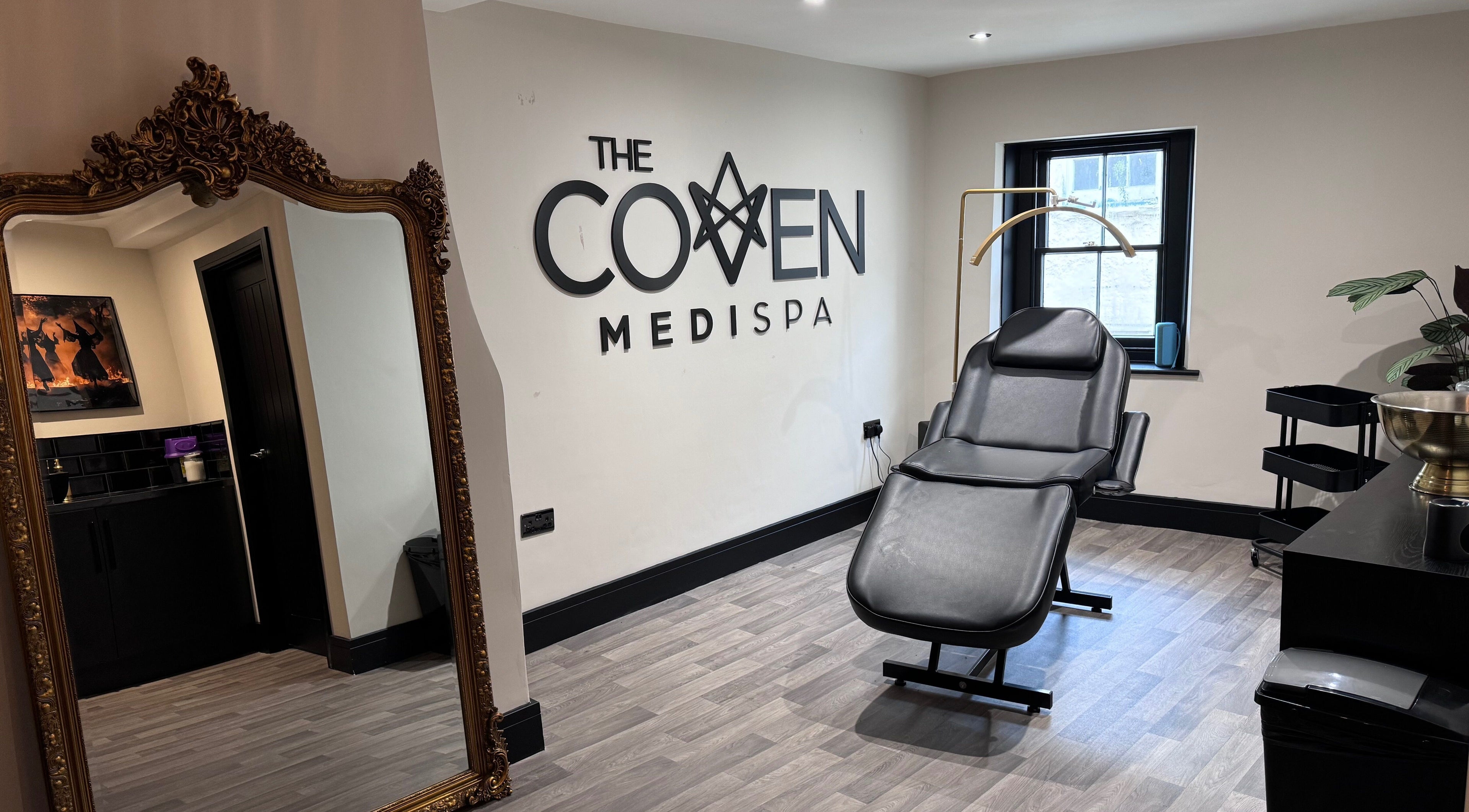 Interior of The Coven- Medi Spa in Bridgend, Wales, GB featuring a reclined spa chair and ornate mirror.