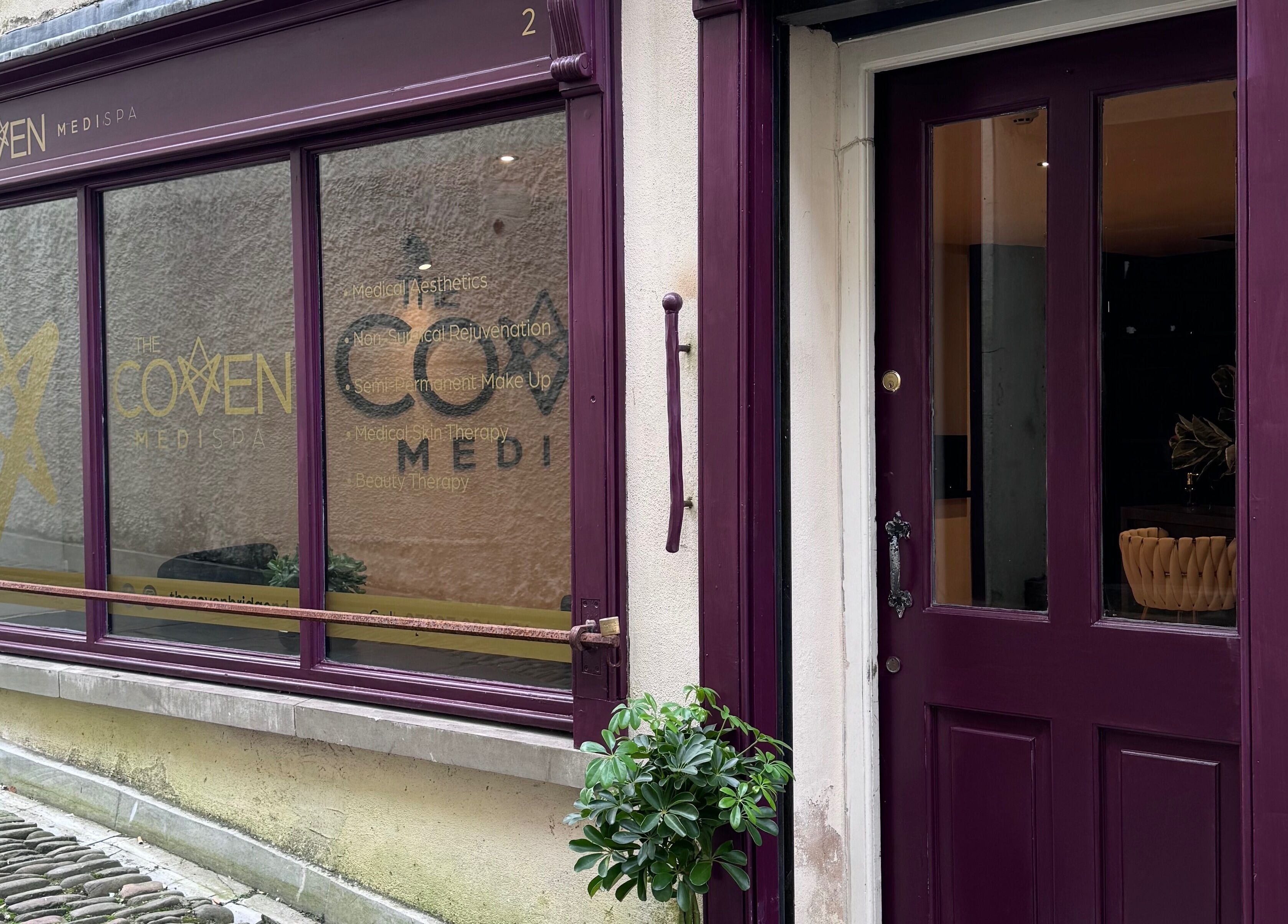 Entrance of The Coven-Medi Spa with maroon doors in Bridgend, Wales, GB showcasing elegant design.