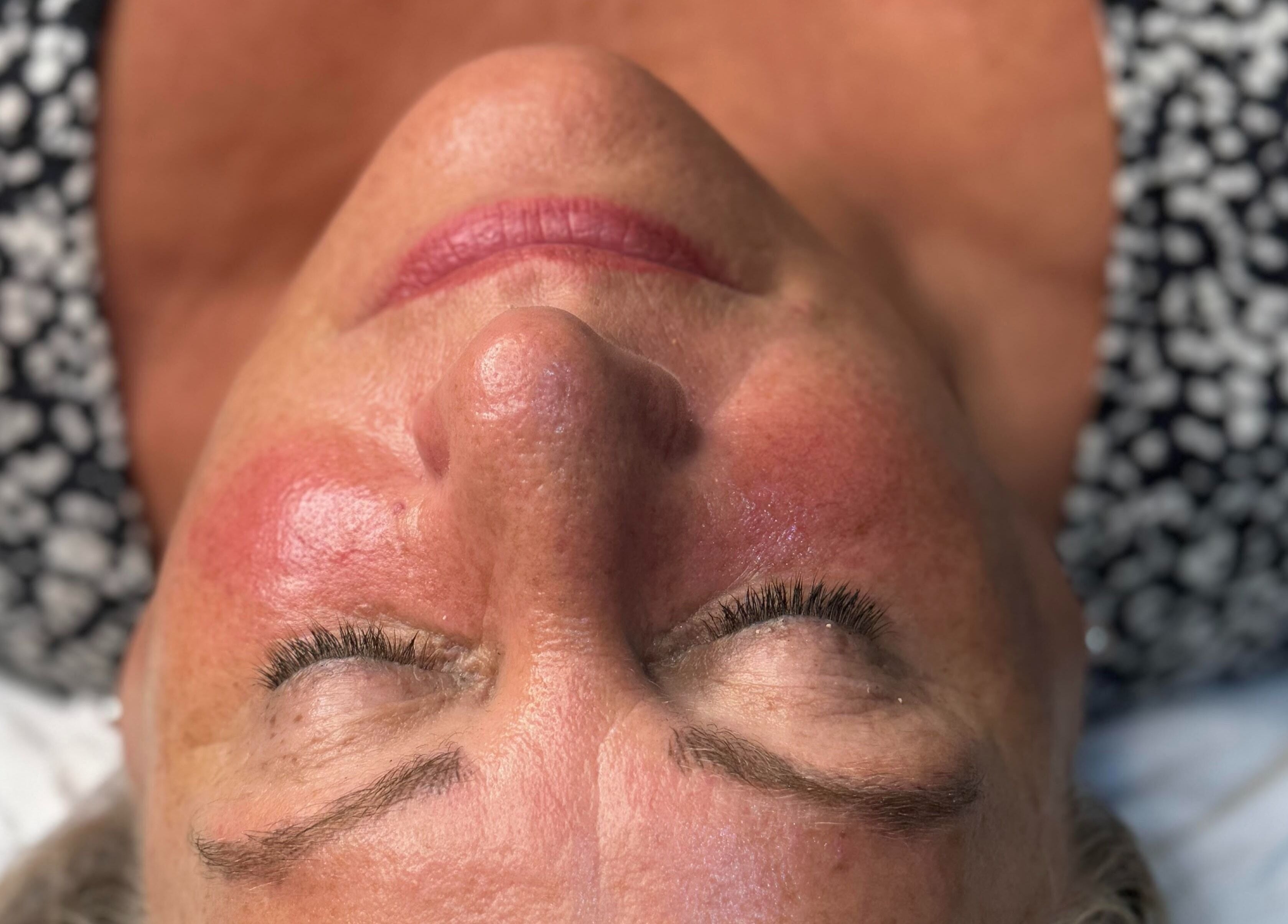 Relaxed client enjoying facial at The Coven- Medi Spa, Bridgend, Wales, GB.