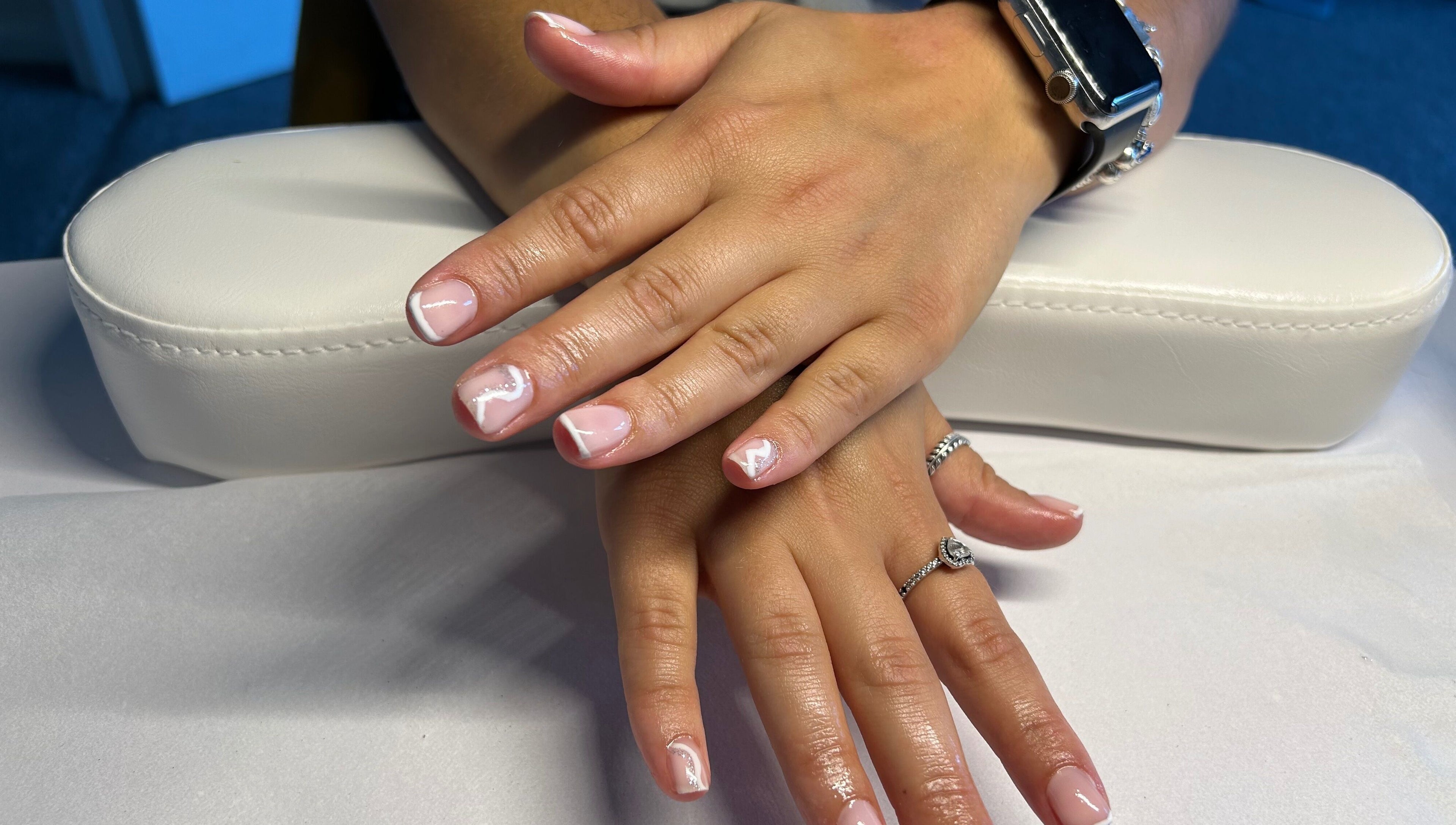 Chic nail art on hands showcasing trendy white designs at B's Nails, Gosport, England, GB.