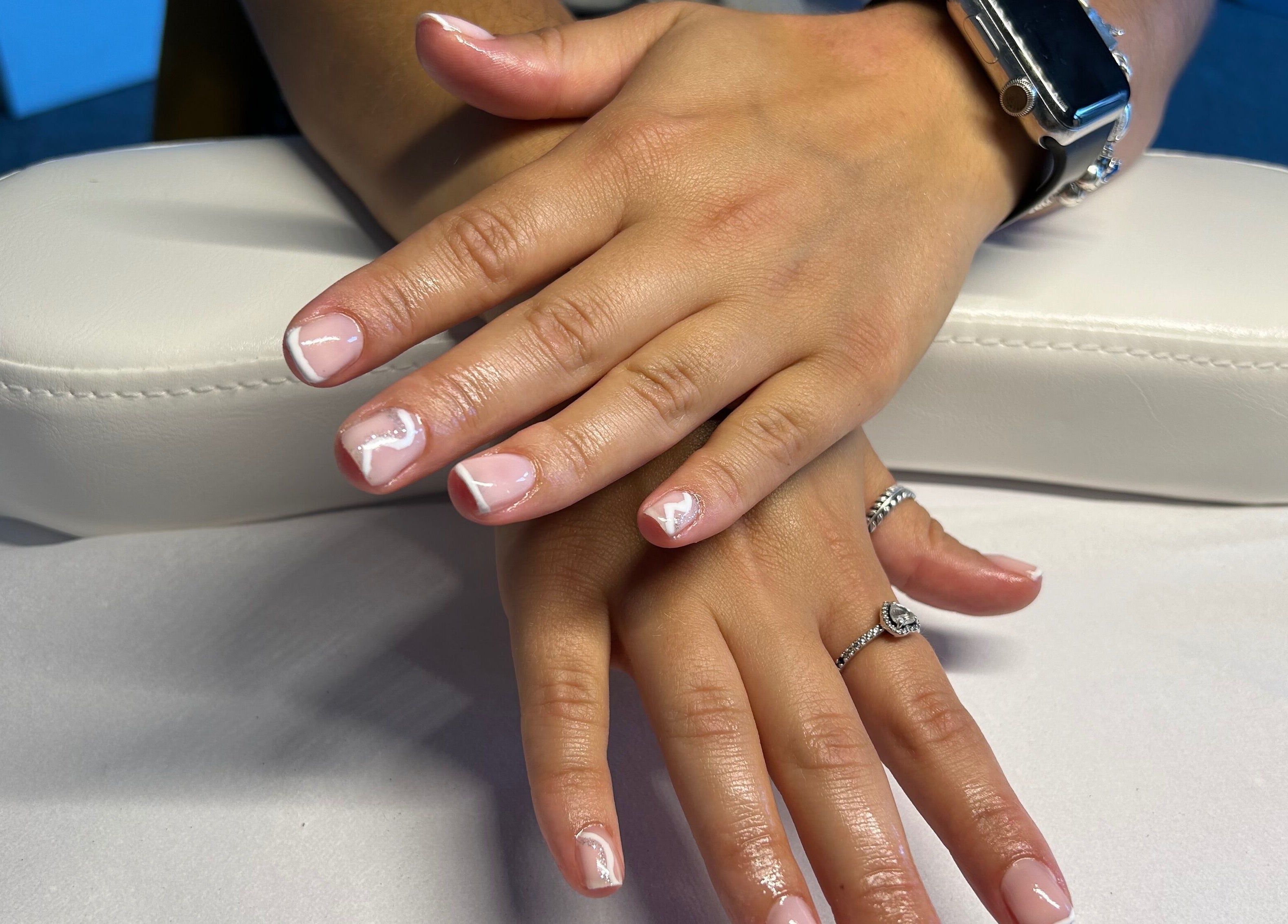 Chic nail art on hands showcasing trendy white designs at B's Nails, Gosport, England, GB.