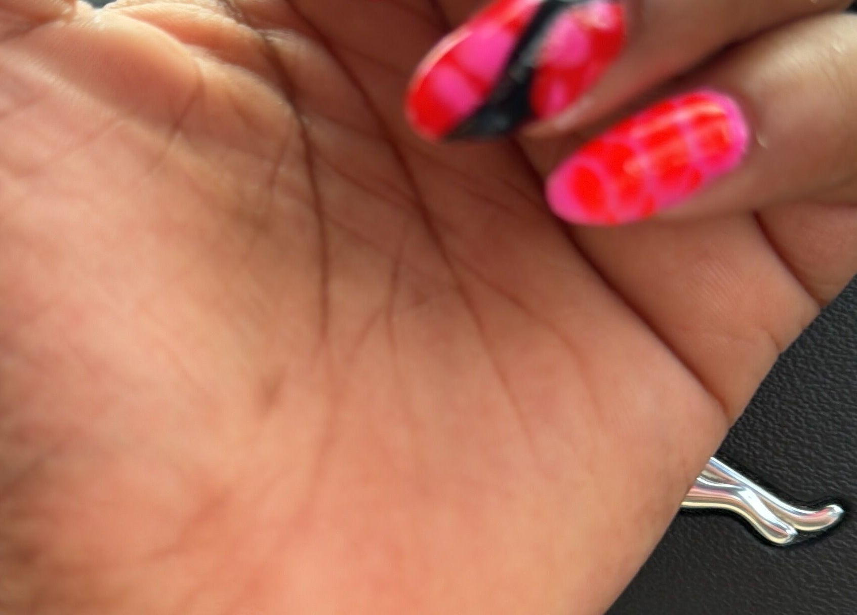 Brightly painted nails with intricate design at B's Nails, Gosport, England, GB.