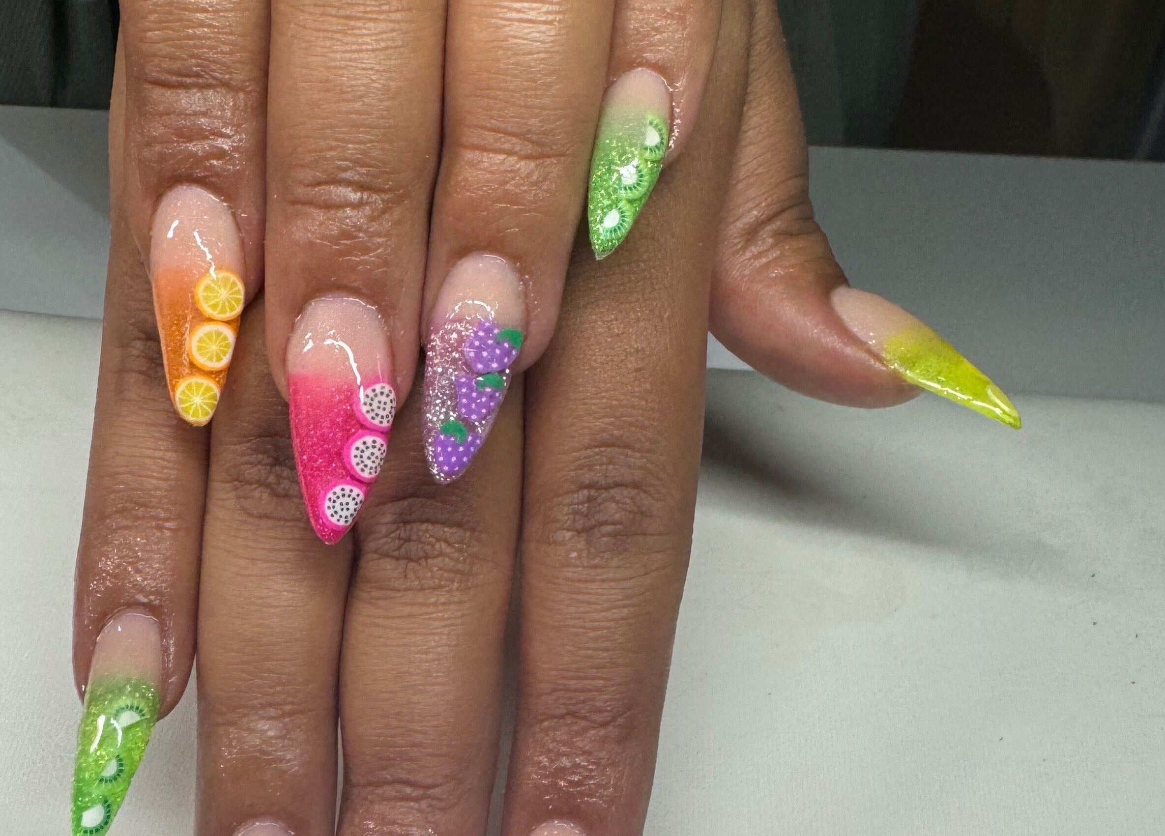 Colorful fruit-themed nail art at B's Nails, Gosport, England, GB. Features intricate citrus and berry designs.