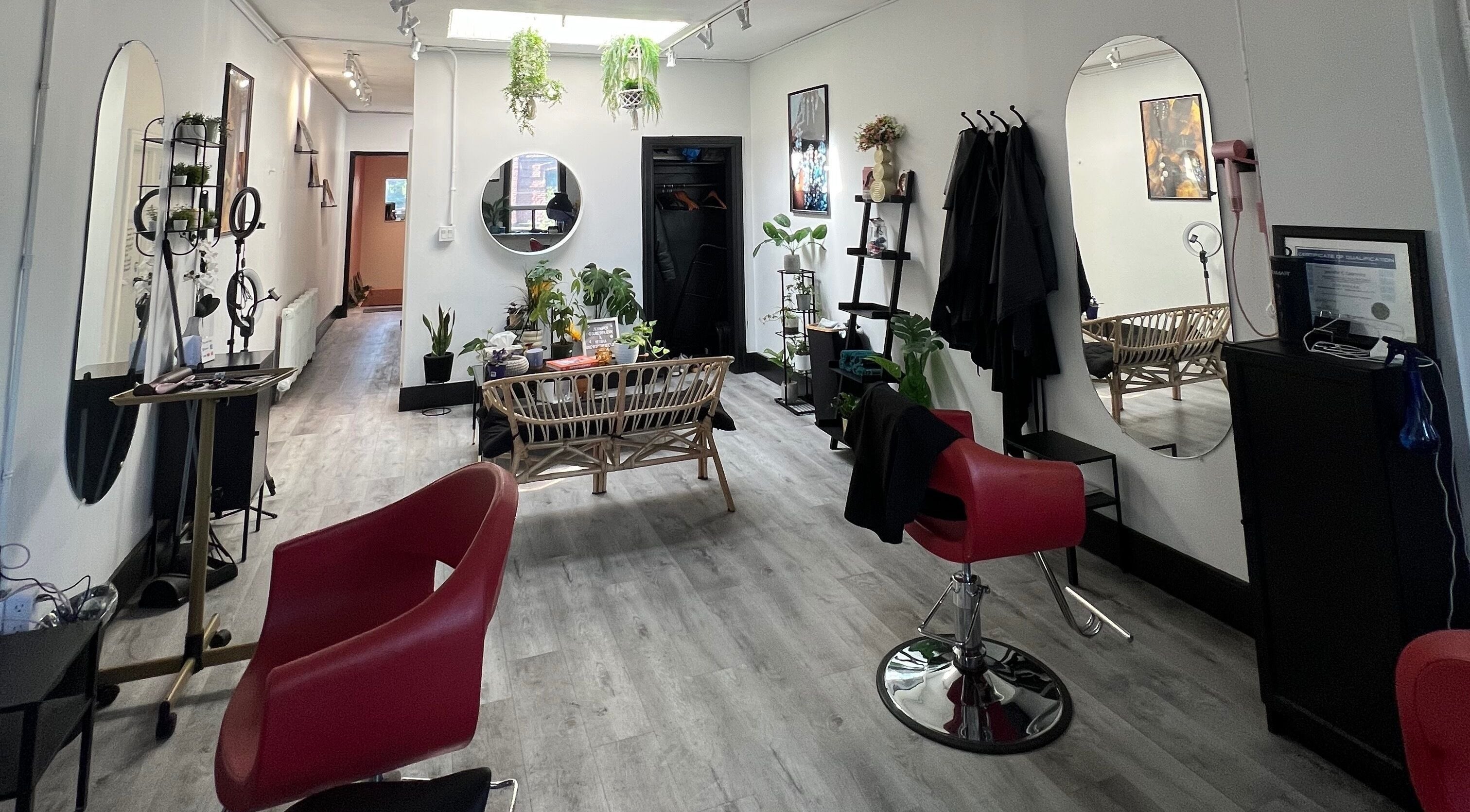 Modern salon interior at Curls by Jenn, Toronto, Ontario, CA, with stylish decor and vibrant plants.