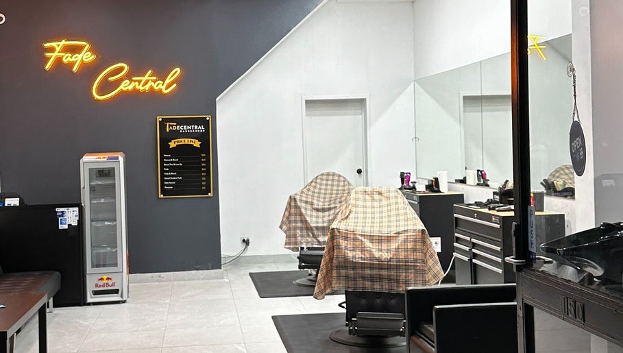 Interior of FadeCentral Barbershop, Enfield, NSW featuring two covered barber chairs and illuminated sign.
