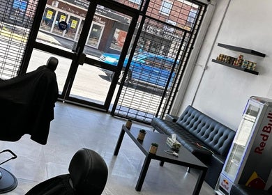 Modern interior of FadeCentral Barbershop, Enfield, New South Wales, AU, featuring a sleek waiting area.