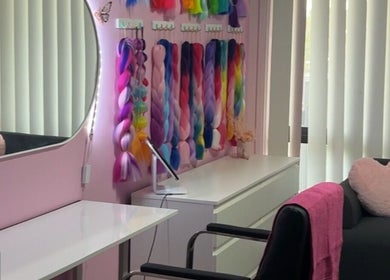 Vibrant braids at Mad's Beauty Bar in Gregory Hills, New South Wales, AU. Cozy seating in modern salon decor.