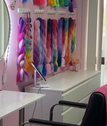 Vibrant braids at Mad's Beauty Bar in Gregory Hills, New South Wales, AU. Cozy seating in modern salon decor.