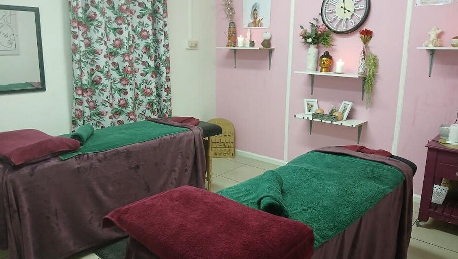 Relaxing treatment room at Burgundy Blush Beauty Lounge, George, Western Cape, ZA with floral decor and comfy beds.