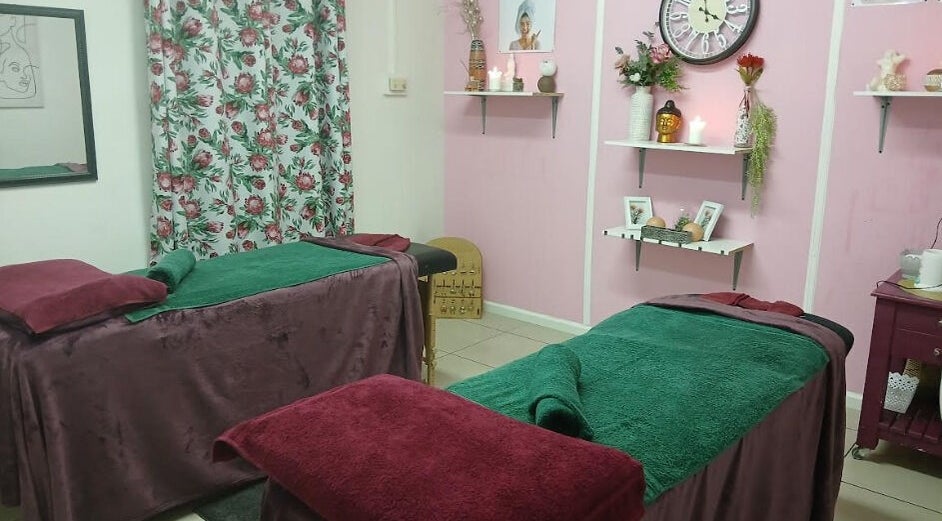 Relaxing treatment room at Burgundy Blush Beauty Lounge, George, Western Cape, ZA with floral decor and comfy beds.