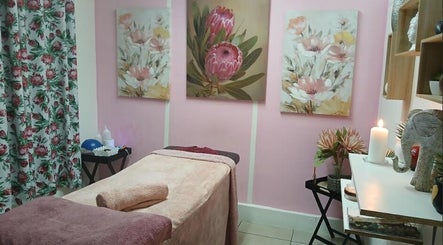 Cozy massage room with floral decor at Burgundy Blush Beauty Lounge, George, Western Cape, ZA.