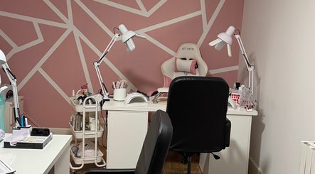 Stylish nail salon interior at Larissa Albernaz, Gort, County Galway, IE with pink geometric walls and modern furniture.