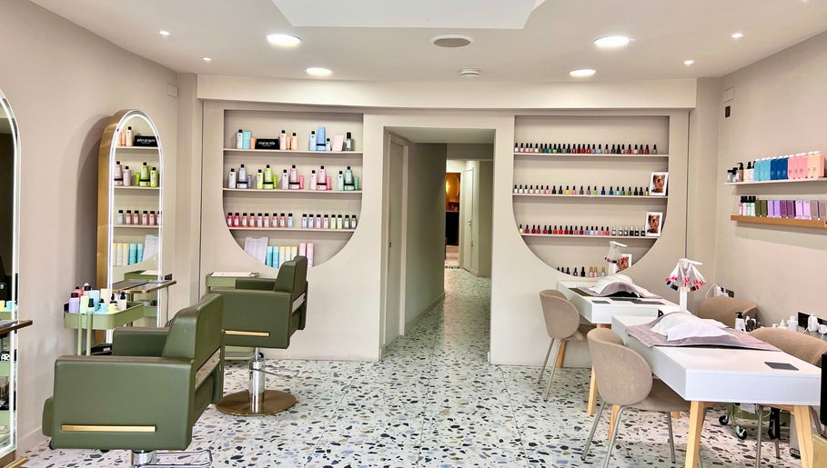 Interior of Mami Yaba Salon in London, England, GB featuring stylish chairs and nail polish display.