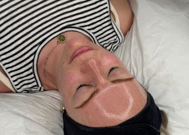 Client relaxing with glowing skin after treatment at The Derma Clinic Cheshire, Hyde, England, GB.