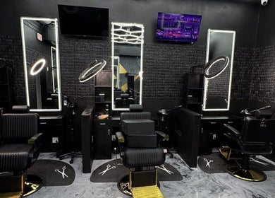 Modern barber chairs and mirrors in Milez Cutz, Nassau, New Providence, BS, showcasing stylish salon interior.