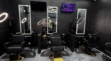 Modern barber chairs and mirrors in Milez Cutz, Nassau, New Providence, BS, showcasing stylish salon interior.