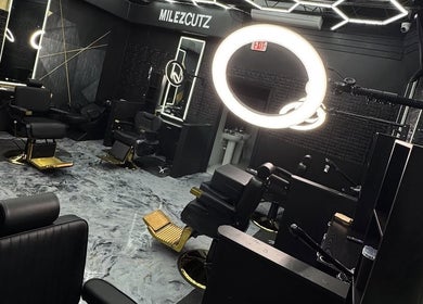 Modern interior of Milez Cutz in Nassau, New Providence, BS with stylish black chairs and bright lighting.