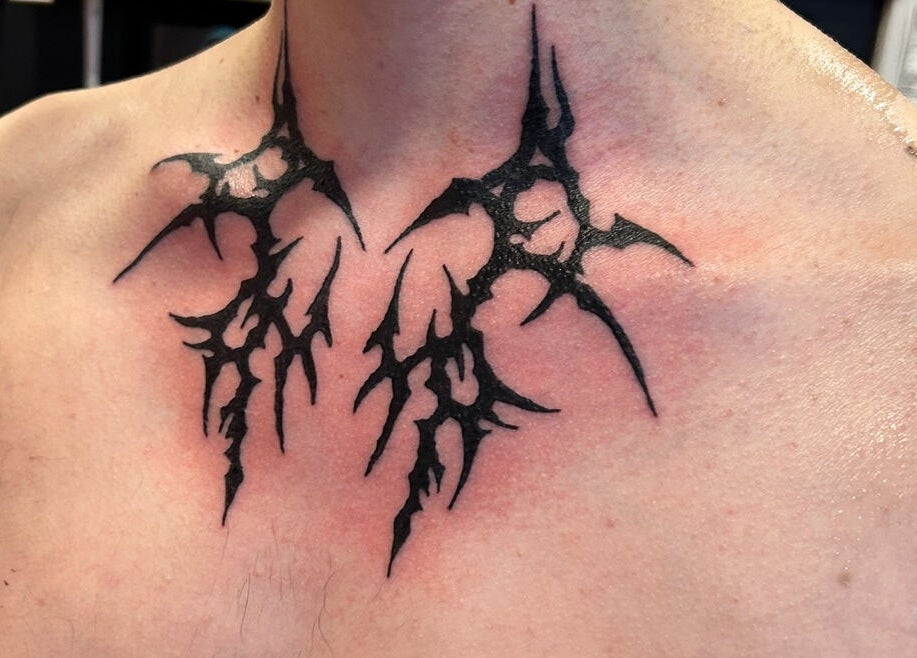 Unique neck tattoo at Dark Dimension Tattoo in Calgary, Alberta, CA. Intricate black line design.