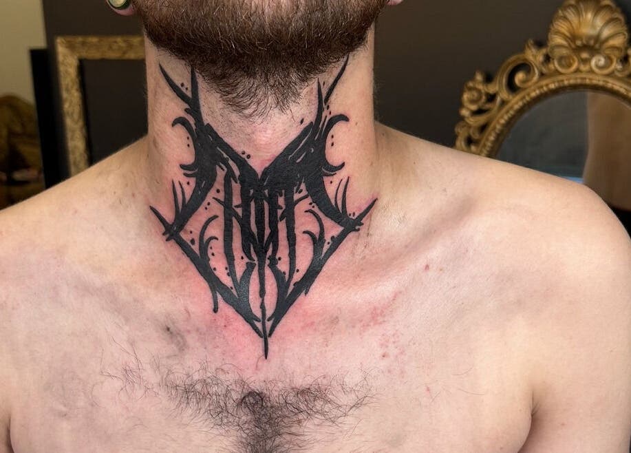 Intricate black tattoo on neck at Dark Dimension Tattoo, Calgary, Alberta, CA.