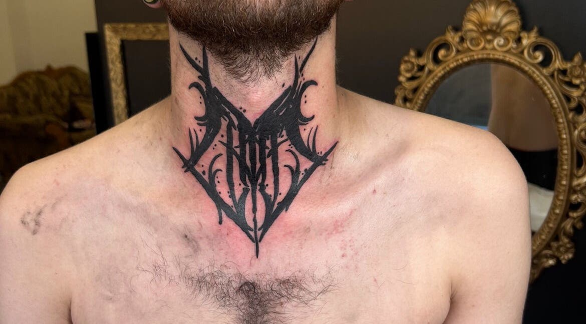 Intricate black tattoo on neck at Dark Dimension Tattoo, Calgary, Alberta, CA.