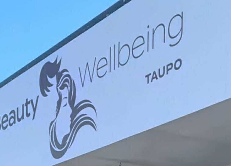 Exterior sign of Sleek Brows & CornBraids in Taupō, Waikato, NZ displaying 'Hair Beauty Wellbeing'.