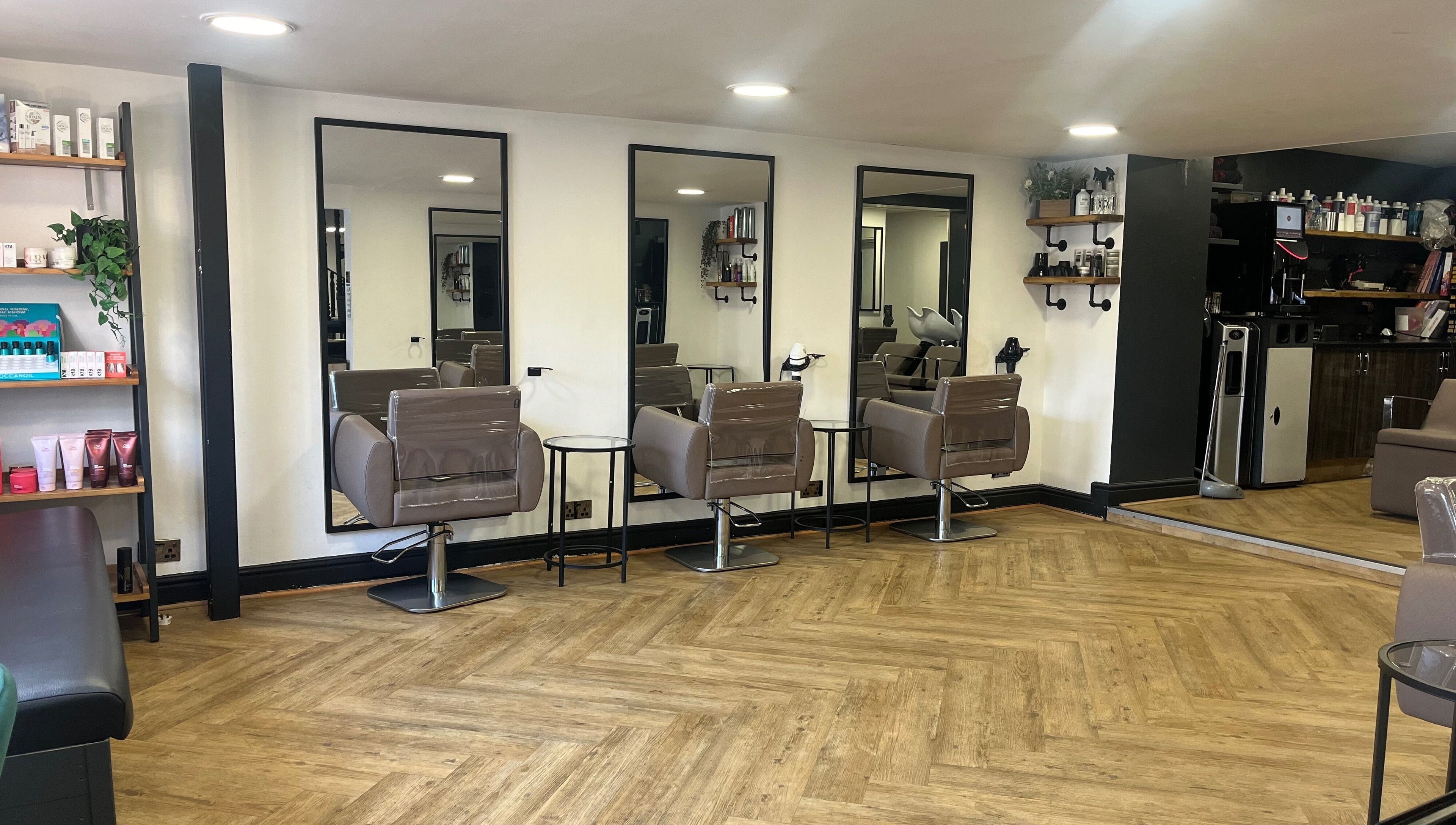 Modern salon chairs and mirrors at House of Finesse, Altrincham, England, GB, showcasing sleek design.