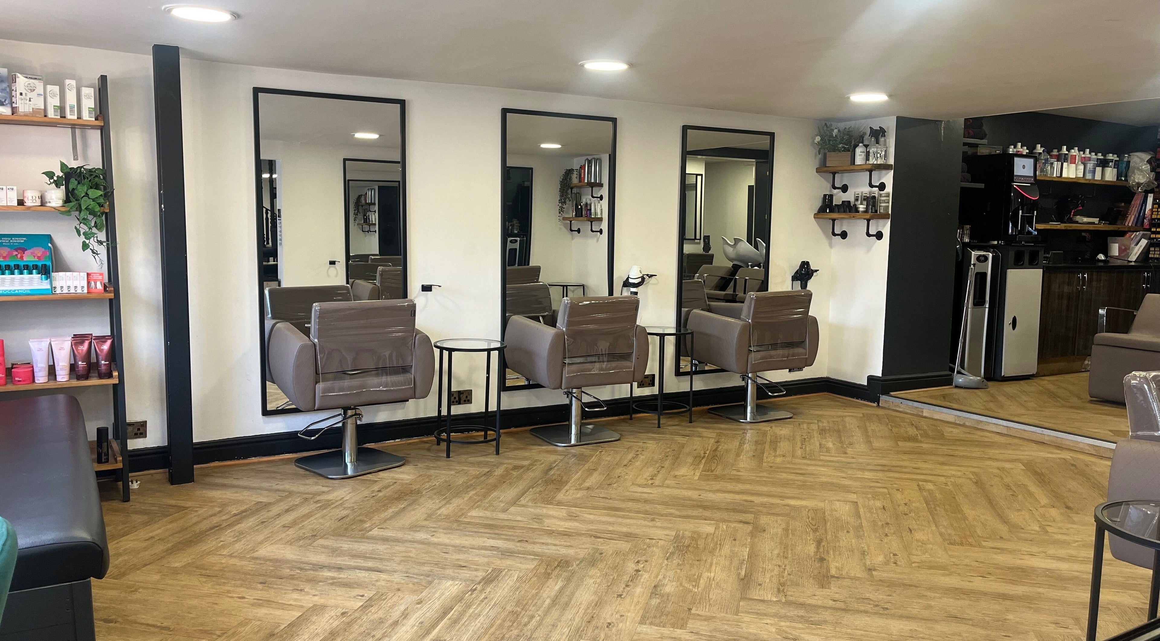 Modern salon chairs and mirrors at House of Finesse, Altrincham, England, GB, showcasing sleek design.
