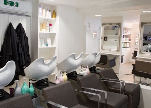 Modern hair salon at House of Finesse, Altrincham, England, GB showcasing chic wash stations and styling chairs.
