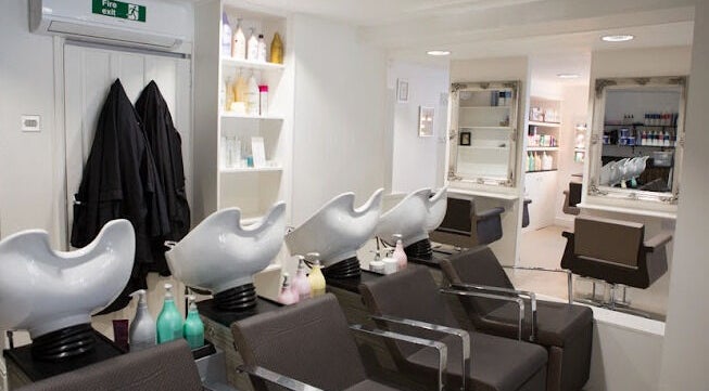 Modern hair salon at House of Finesse, Altrincham, England, GB showcasing chic wash stations and styling chairs.