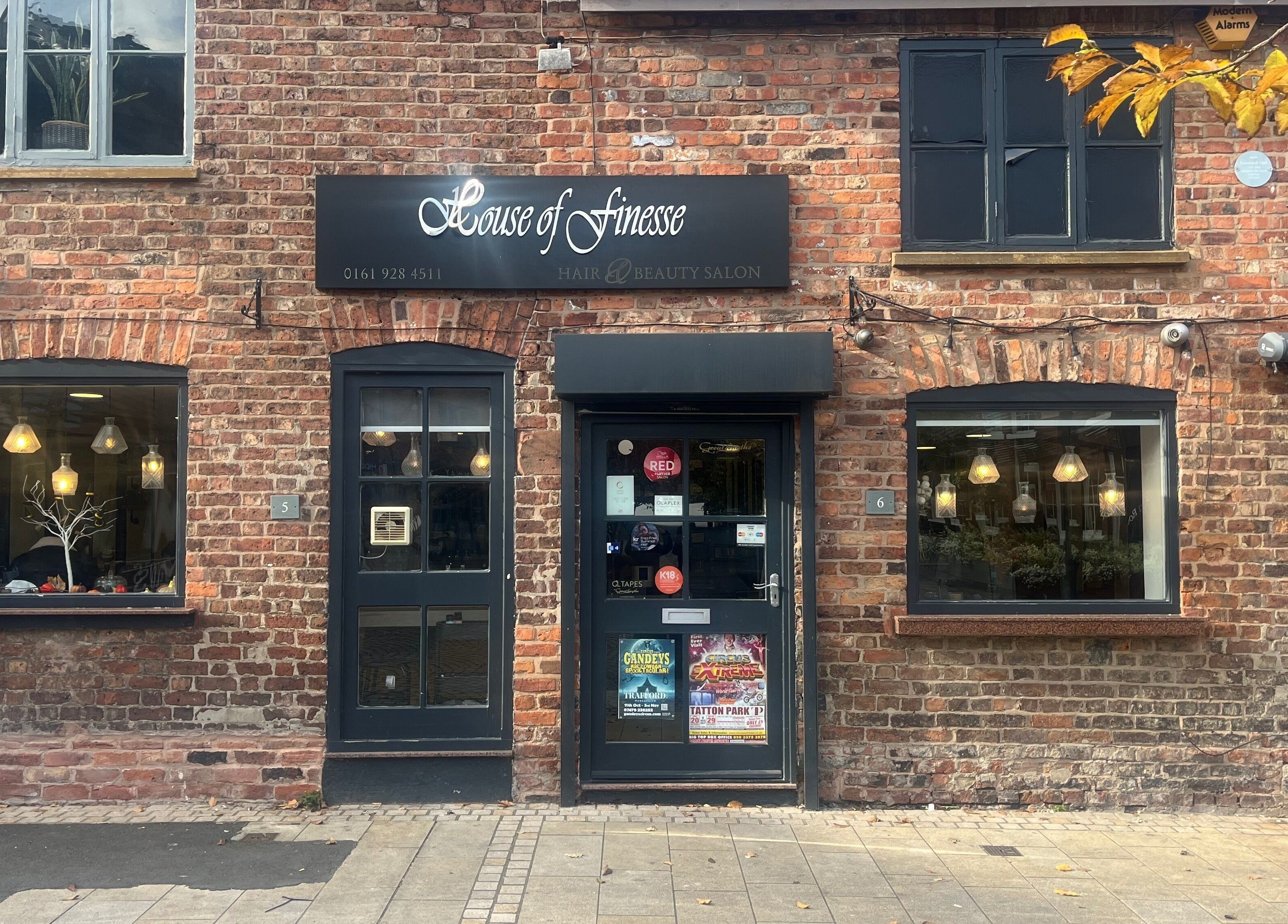 The charming brick facade of House of Finesse in Altrincham, England, GB, with stylish window displays.