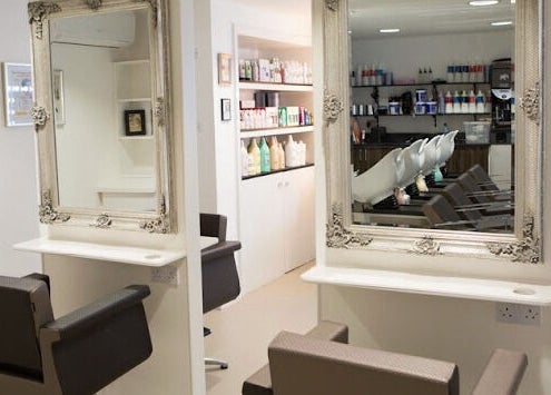 Stylish salon interior at House of Finesse, Altrincham, England, GB, featuring elegant mirrors and chic chairs.