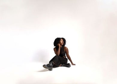 Model exuding elegance in a black outfit at Aidooklik, Accra, Greater Accra Region, GH.