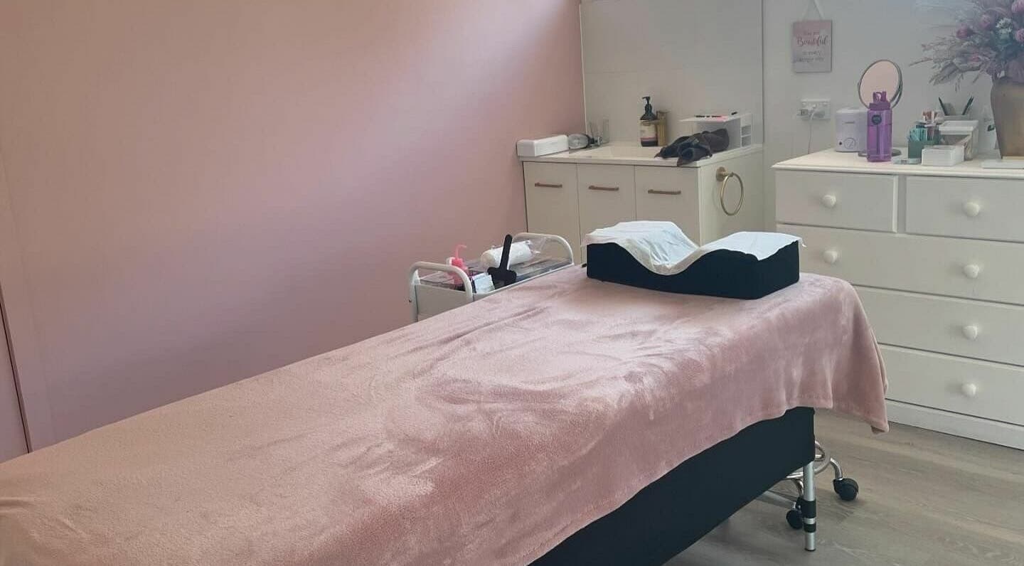 Relaxing treatment room at Crown of Glow Beauty, Cardigan, Victoria, AU with a plush pink blanket on the table.