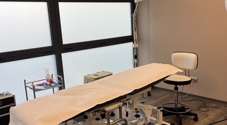 Sala trattamenti presso Manuela Poloni - Caselle di Altivole, Veneto, IT, con letto e sedie moderne.
