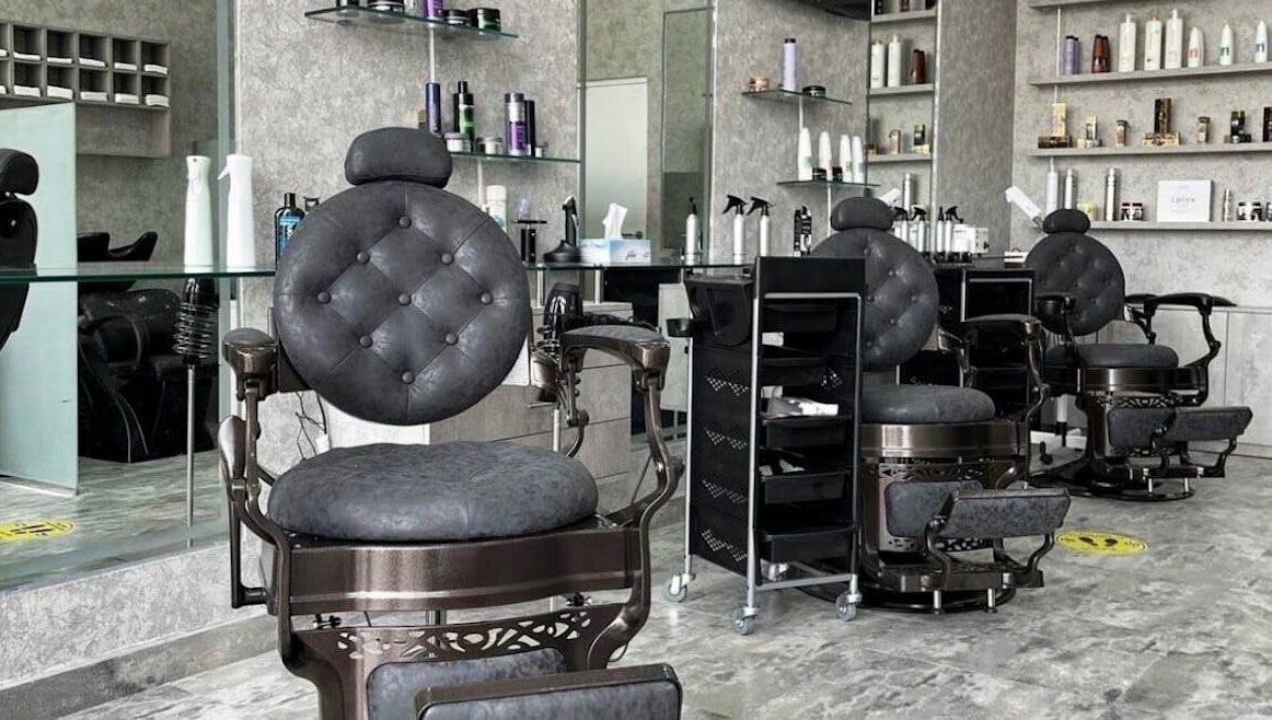 Elegant barber chairs in Barber Bro Gents Salon, Dubai, AE. Modern and stylish interior features premium styling products.