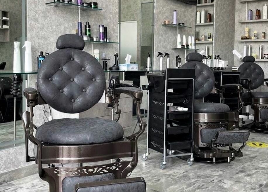 Elegant barber chairs in Barber Bro Gents Salon, Dubai, AE. Modern and stylish interior features premium styling products.