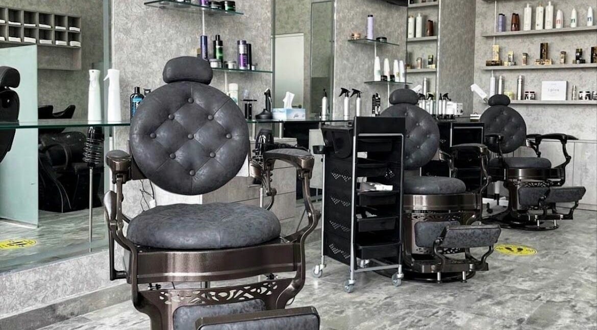Elegant barber chairs in Barber Bro Gents Salon, Dubai, AE. Modern and stylish interior features premium styling products.